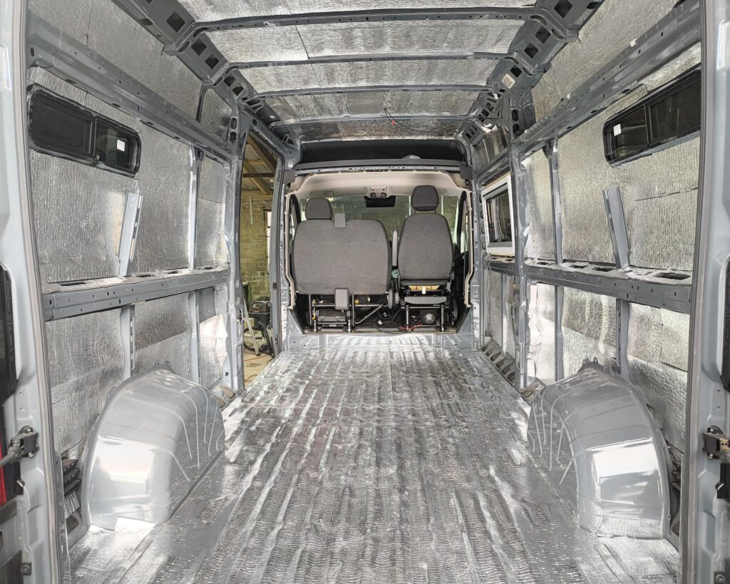 Campervan insulation installation with foil insulation and sound deadening fitted in a panel van conversion